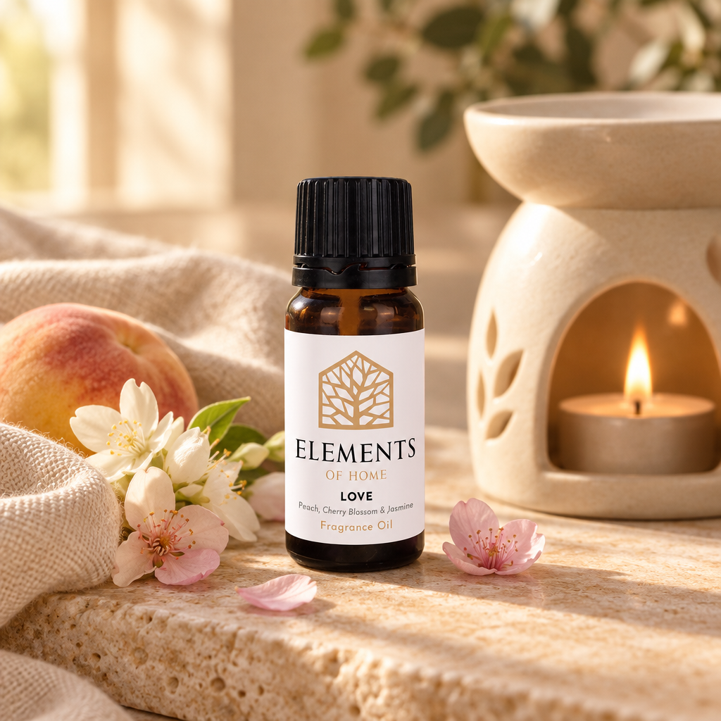 Love fragrance oil 10ml bottle beside a lit ceramic oil burner – Elements of Fragrance