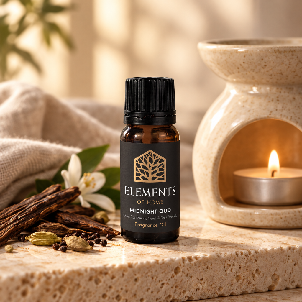 Midnight Oud 10ml fragrance oil beside a lit ceramic oil burner – Elements of Fragrance