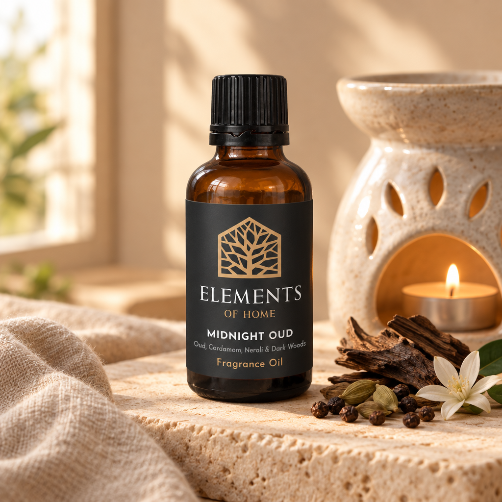 Midnight Oud 30ml fragrance oil beside a lit ceramic oil burner – Elements of Fragrance
