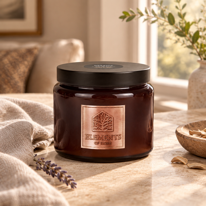 Oceanic 413g luxury candle in an amber glass jar in a cosy living room – Elements of Fragrance