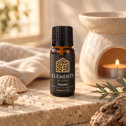 Oceanic 10ml fragrance oil beside a lit ceramic oil burner – Elements of Fragrance