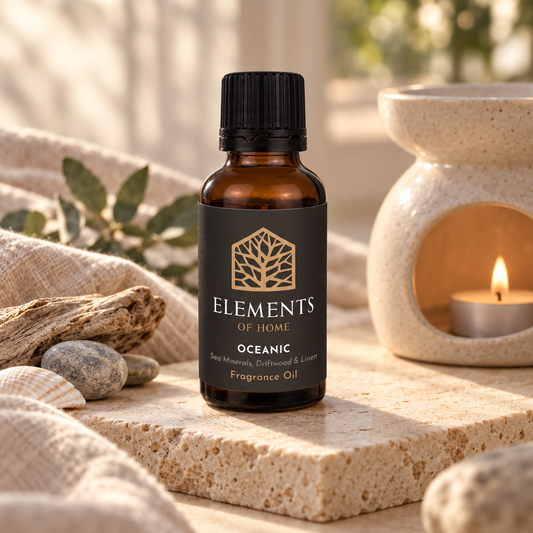 Oceanic 30ml fragrance oil beside a lit ceramic oil burner – Elements of Fragrance