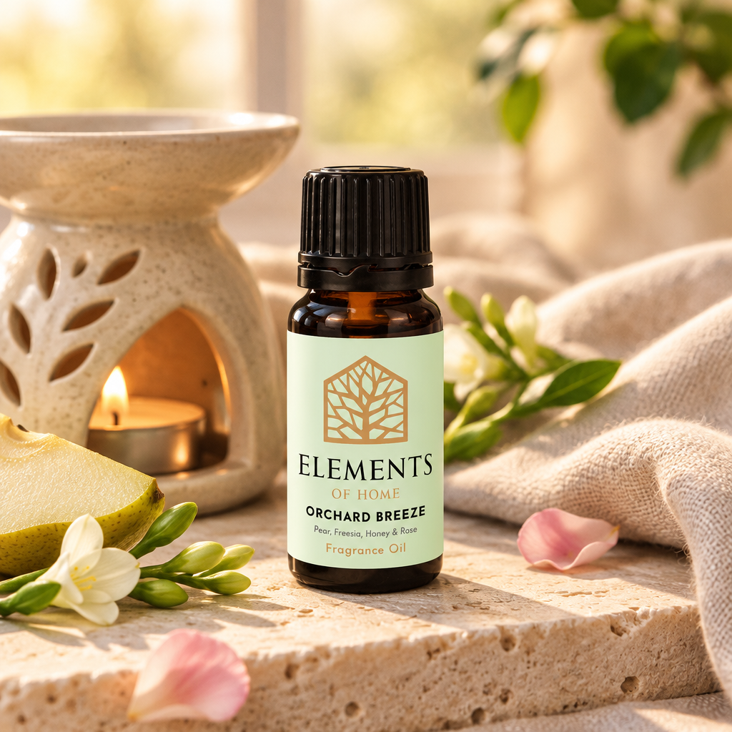 Orchard Breeze fragrance oil 10ml bottle beside a lit ceramic oil burner – Elements of Fragrance