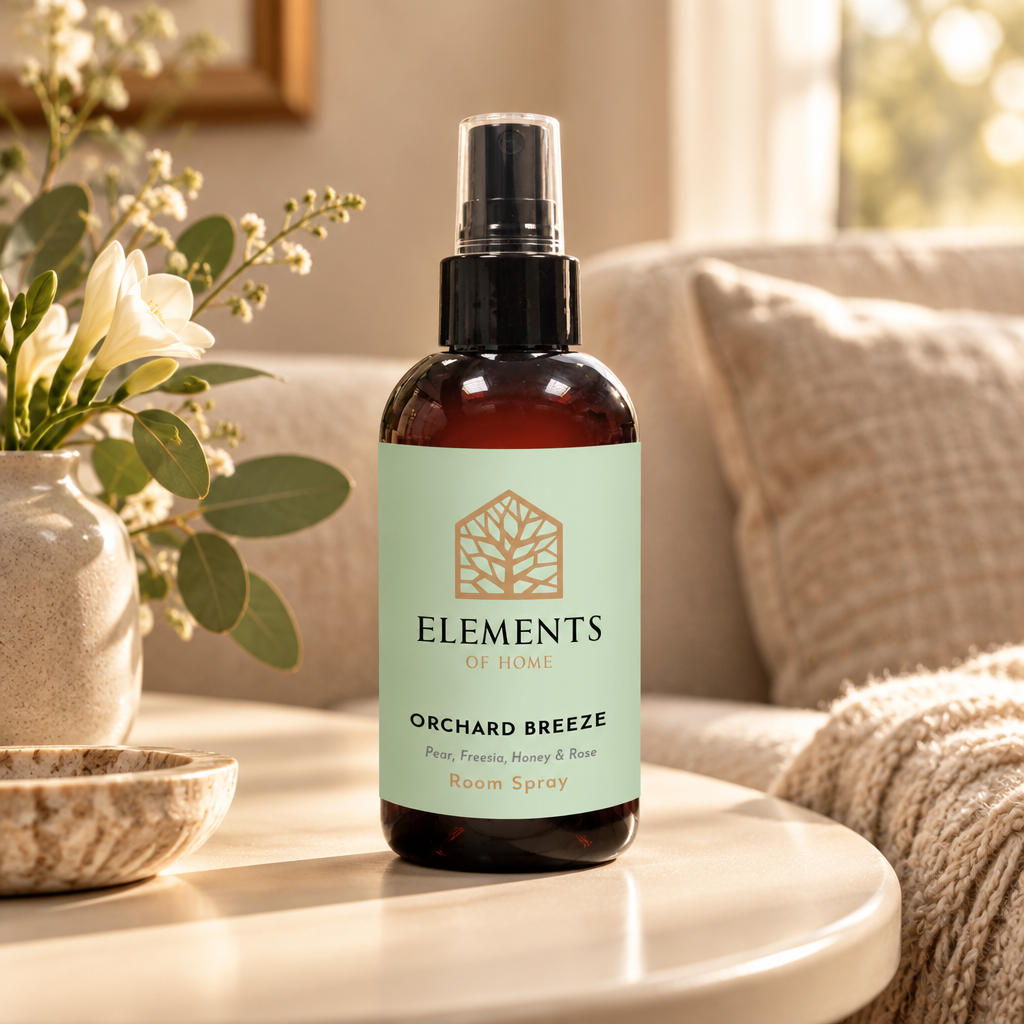 Orchard Breeze room spray on a side table in a sunlit living room – Elements of Fragrance