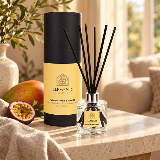 Passionfruit & Mango 100ml reed diffuser with black reeds styled in a sunlit living room – Elements of Fragrance