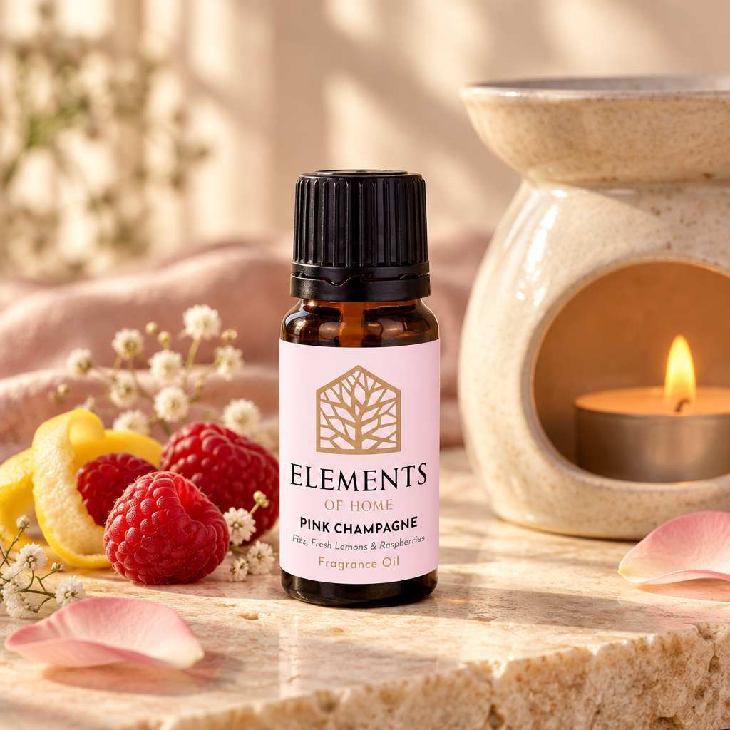 Pink Champagne fragrance oil 10ml bottle beside a lit ceramic oil burner – Elements of Fragrance