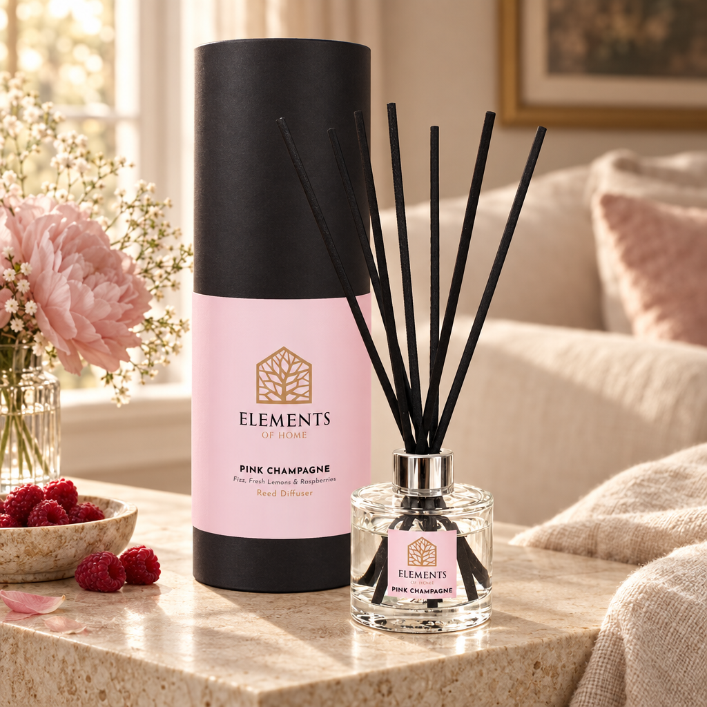 Pink Champagne 100ml reed diffuser with black reeds styled in a sunlit living room – Elements of Fragrance