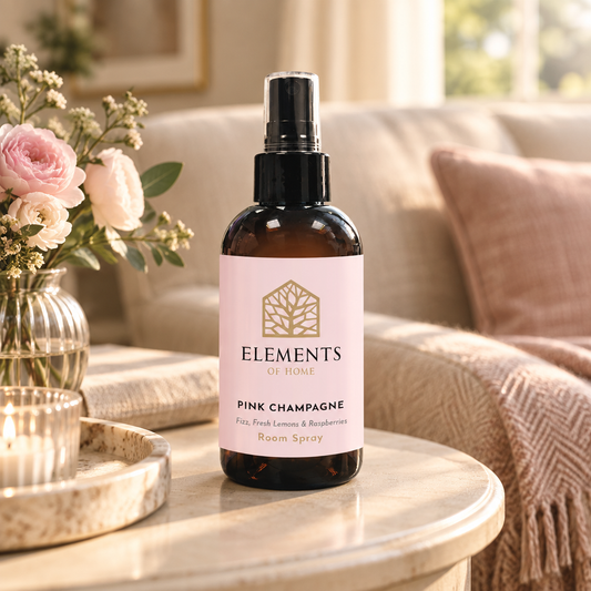 Pink Champagne room spray on a side table in a sunlit living room – Elements of Fragrance