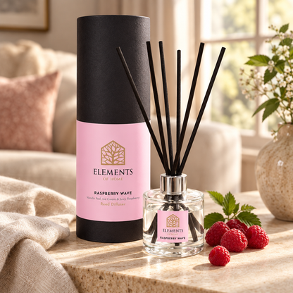 Raspberry Wave 100ml reed diffuser with black reeds styled in a sunlit living room – Elements of Fragrance