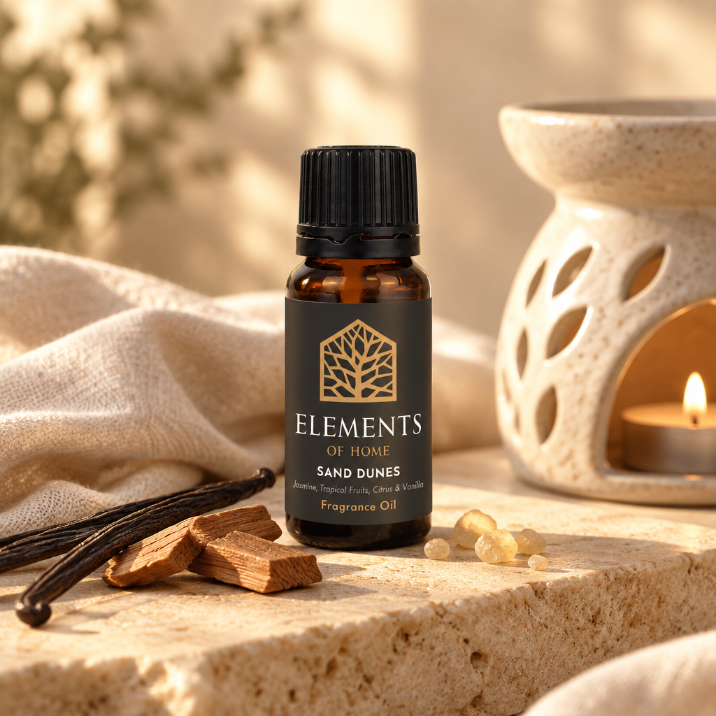 Sand Dunes 10ml fragrance oil beside a lit ceramic oil burner – Elements of Fragrance
