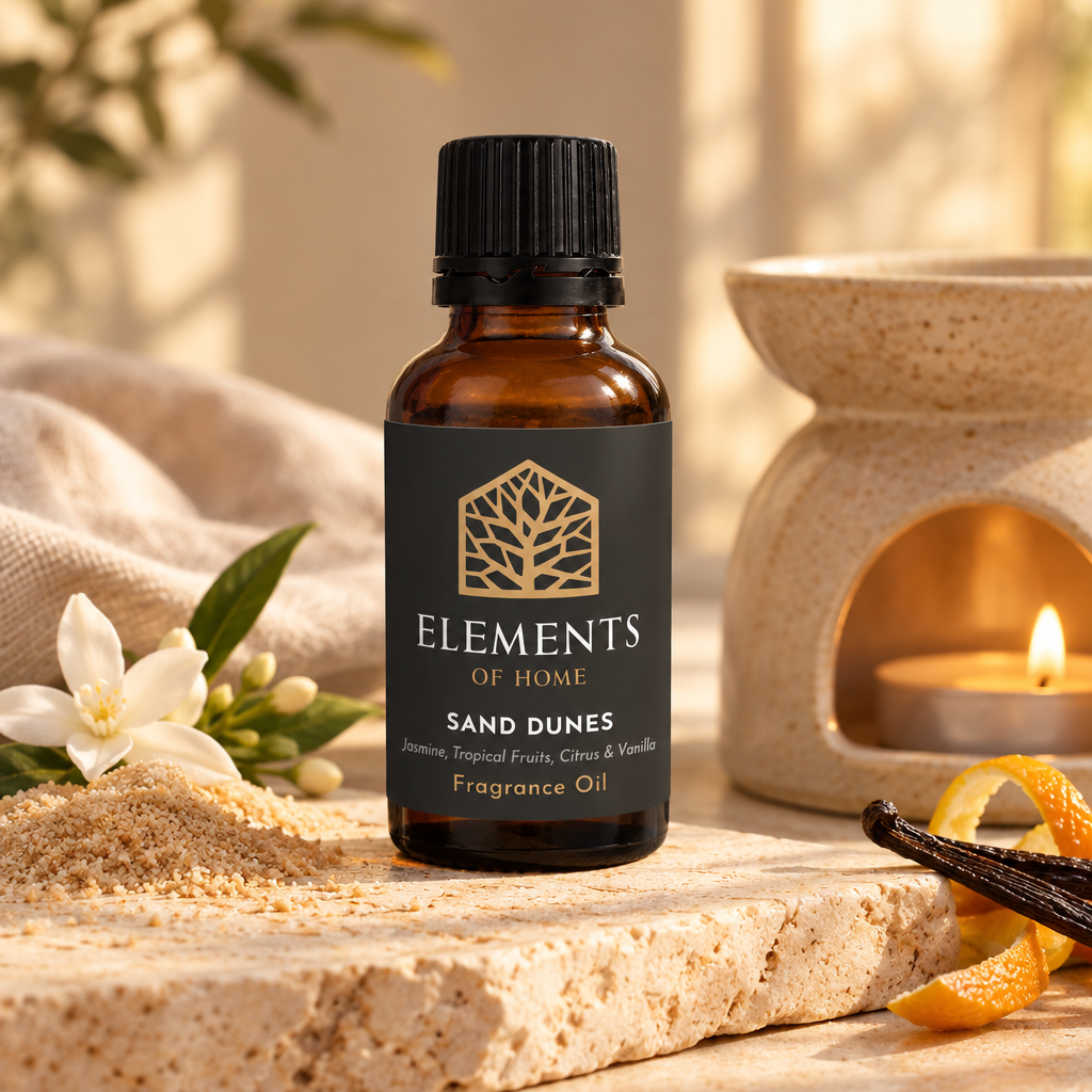 Sand Dunes 30ml fragrance oil beside a lit ceramic oil burner – Elements of Fragrance