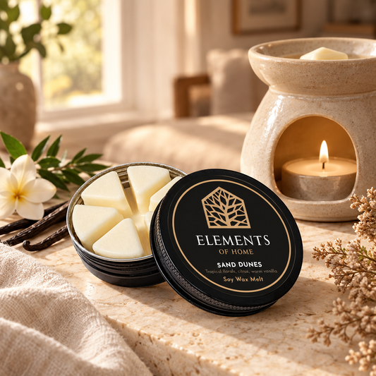 Sand Dunes 50g soy wax melt in a black tin beside a lit ceramic wax burner – Elements of Fragrance
