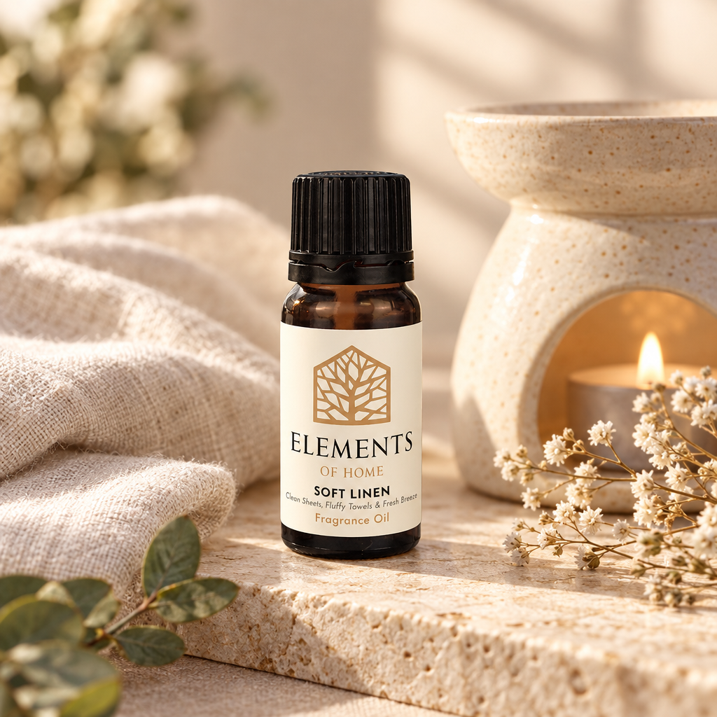 Soft Linen fragrance oil 10ml bottle beside a lit ceramic oil burner – Elements of Fragrance