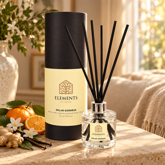 Solar Goddess 100ml reed diffuser with black reeds styled in a sunlit living room – Elements of Fragrance