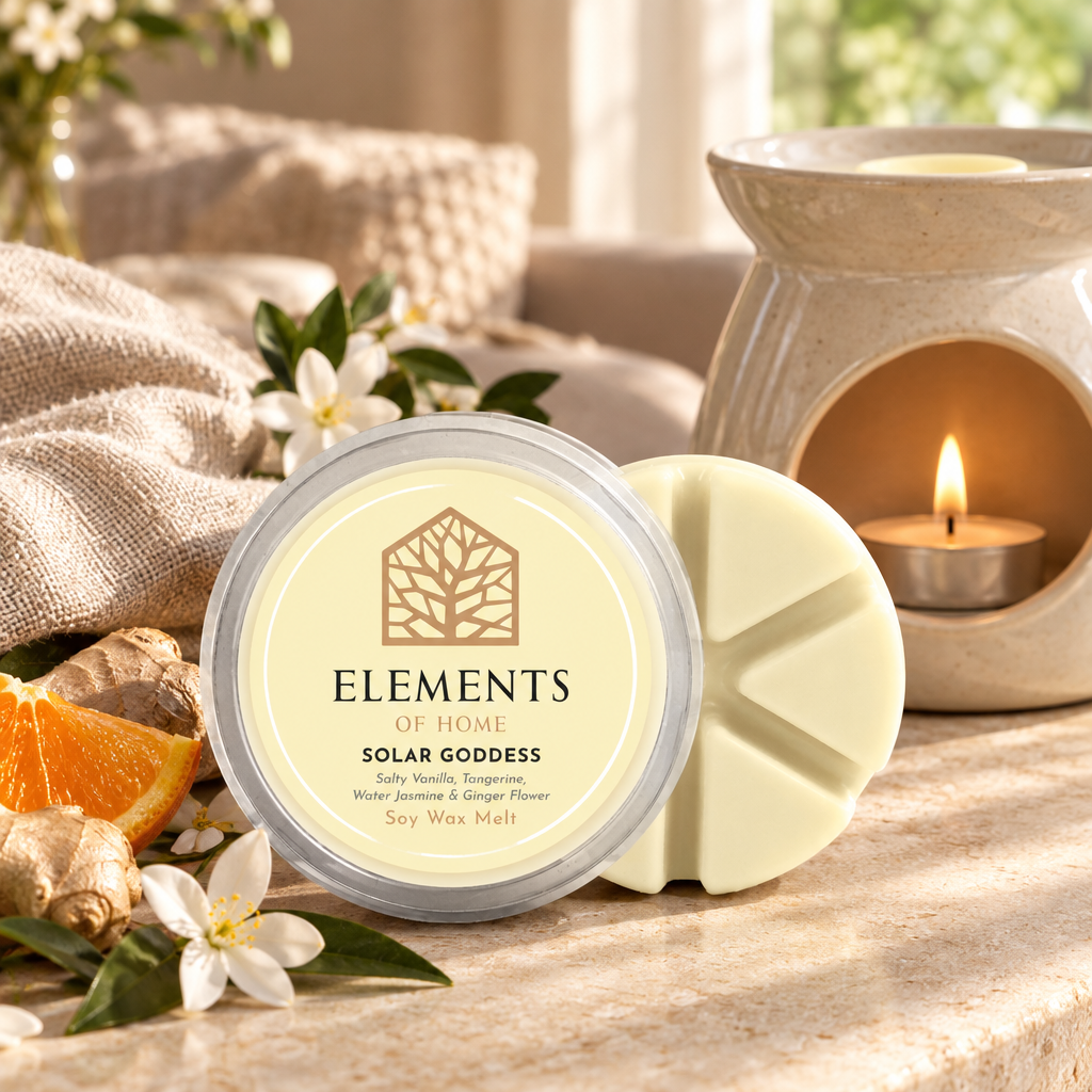 Solar Goddess 50g soy wax melt snap pot beside a lit ceramic wax burner – Elements of Fragrance