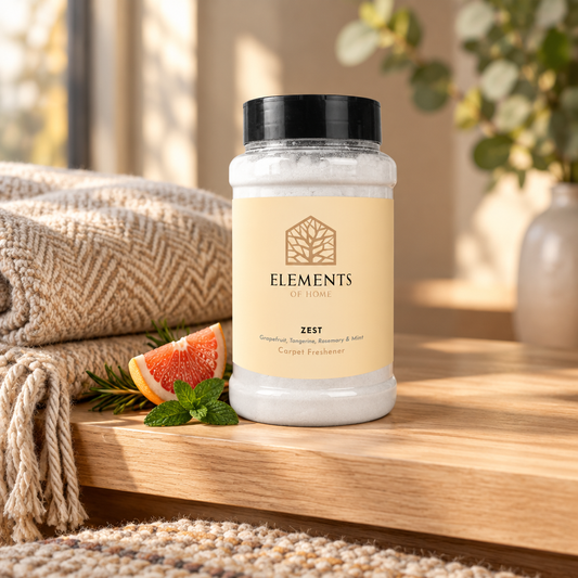 Zest scented carpet sprinkles shaker tub on a wooden shelf with cosy throws – Elements of Fragrance