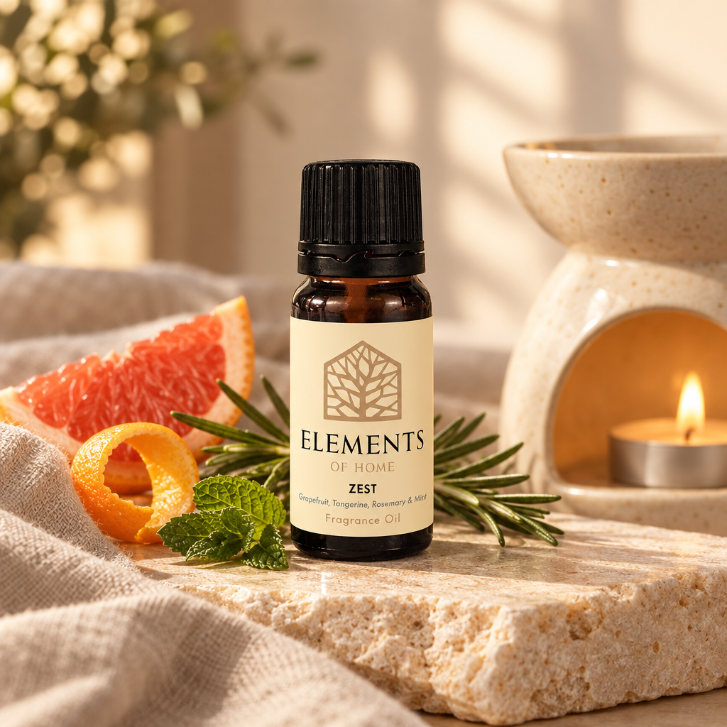 Zest fragrance oil 10ml bottle beside a lit ceramic oil burner – Elements of Fragrance